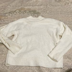 Nikkak Sweater with pearl and cutout accents on sleeves. WUC